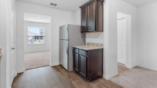 a kitchen with stainless steel appliances granite countertop a refrigerator and a sink