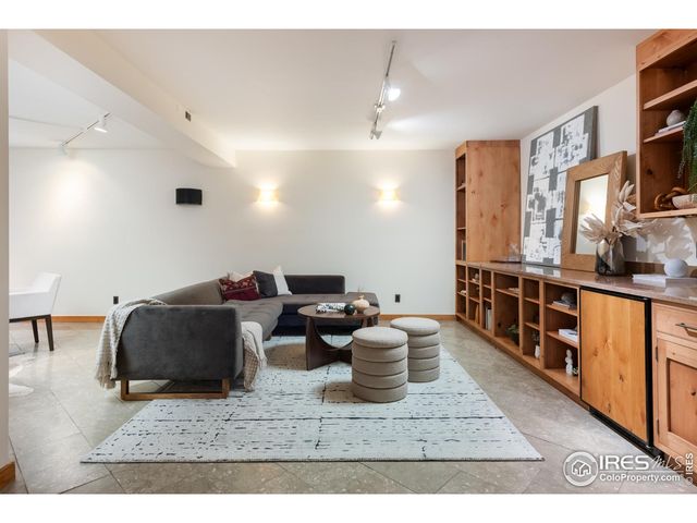 a room with stainless steel appliances kitchen island granite countertop a sink and cabinets
