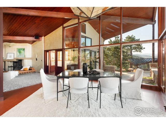a view of a dining room with furniture wooden floor and a potted plant