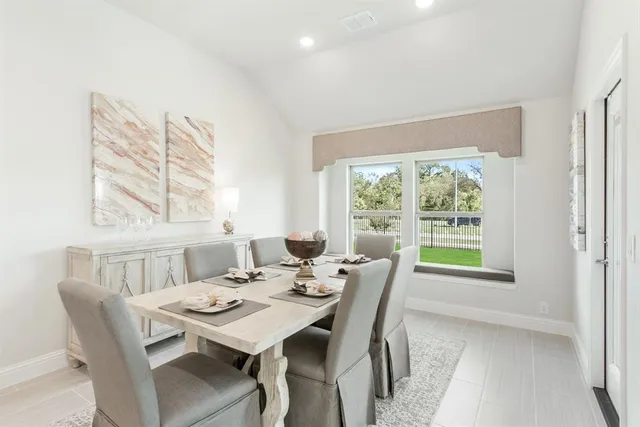 a view of a dining room with furniture and a window