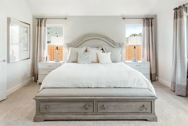 a spacious bedroom with a bed a couch and a window