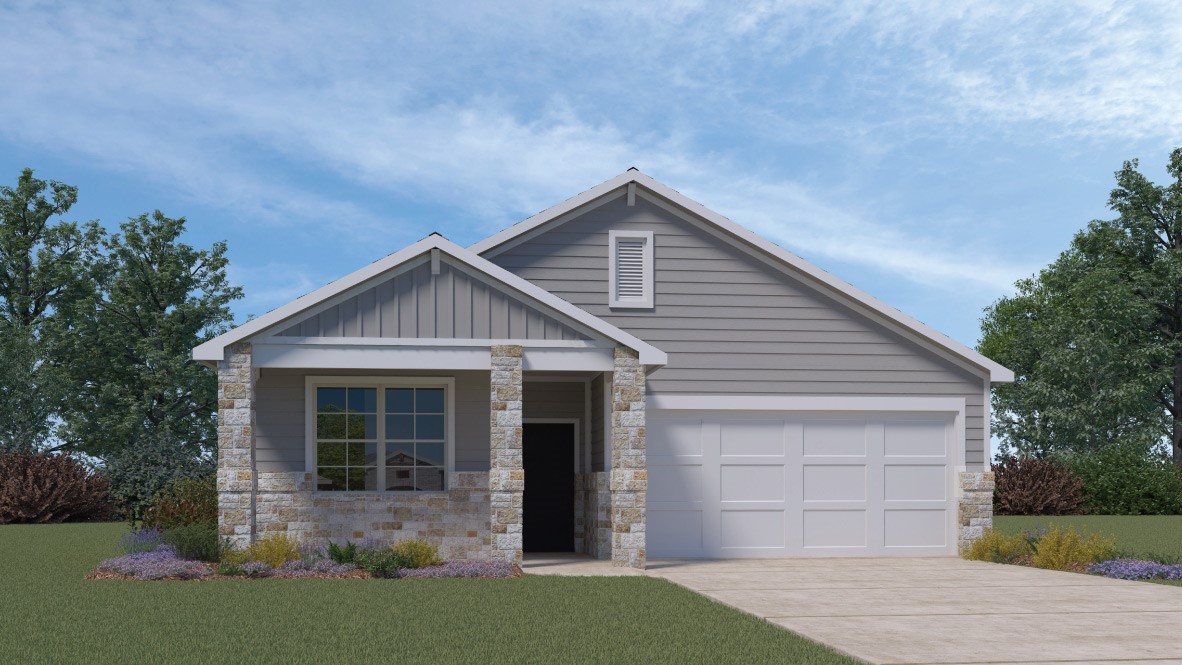 a front view of a house with a garden and yard