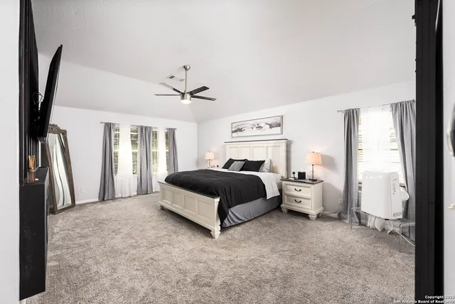 a spacious bedroom with a bed and a large window