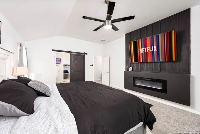 a bedroom with a bed and a fireplace