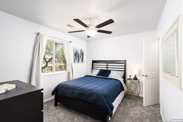 a bedroom with a bed and a window