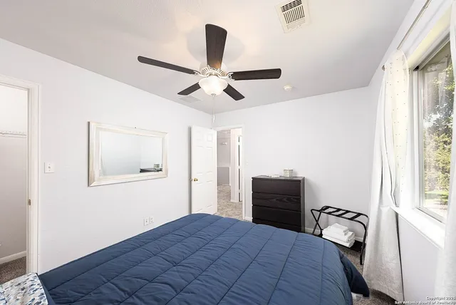 a bedroom with a bed and a window