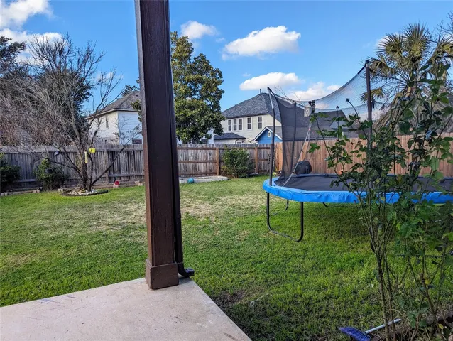 a view of a chair and table in backyard of the house