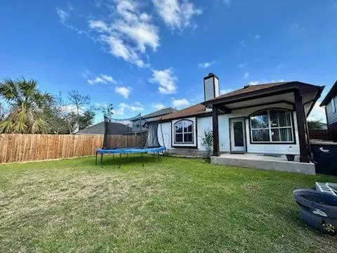 a backyard of a house with table and chairs