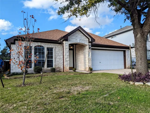 a front view of a house with a garden