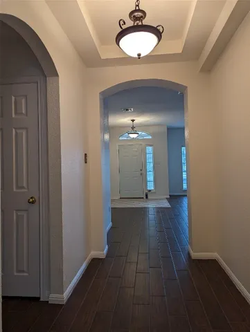 a view of a room with wooden floor