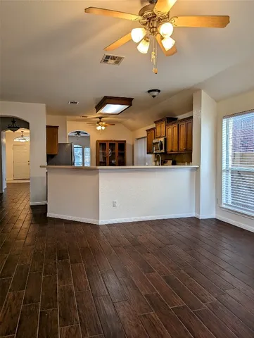 a view of a kitchen with wooden floor and a kitchen space