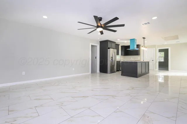 a view of a livingroom with a kitchen