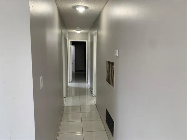 a view of hallway with chandelier