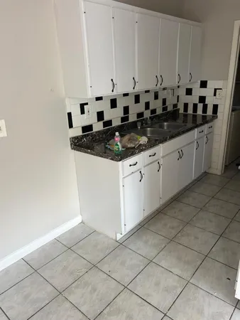 a kitchen with stainless steel appliances a sink and cabinets