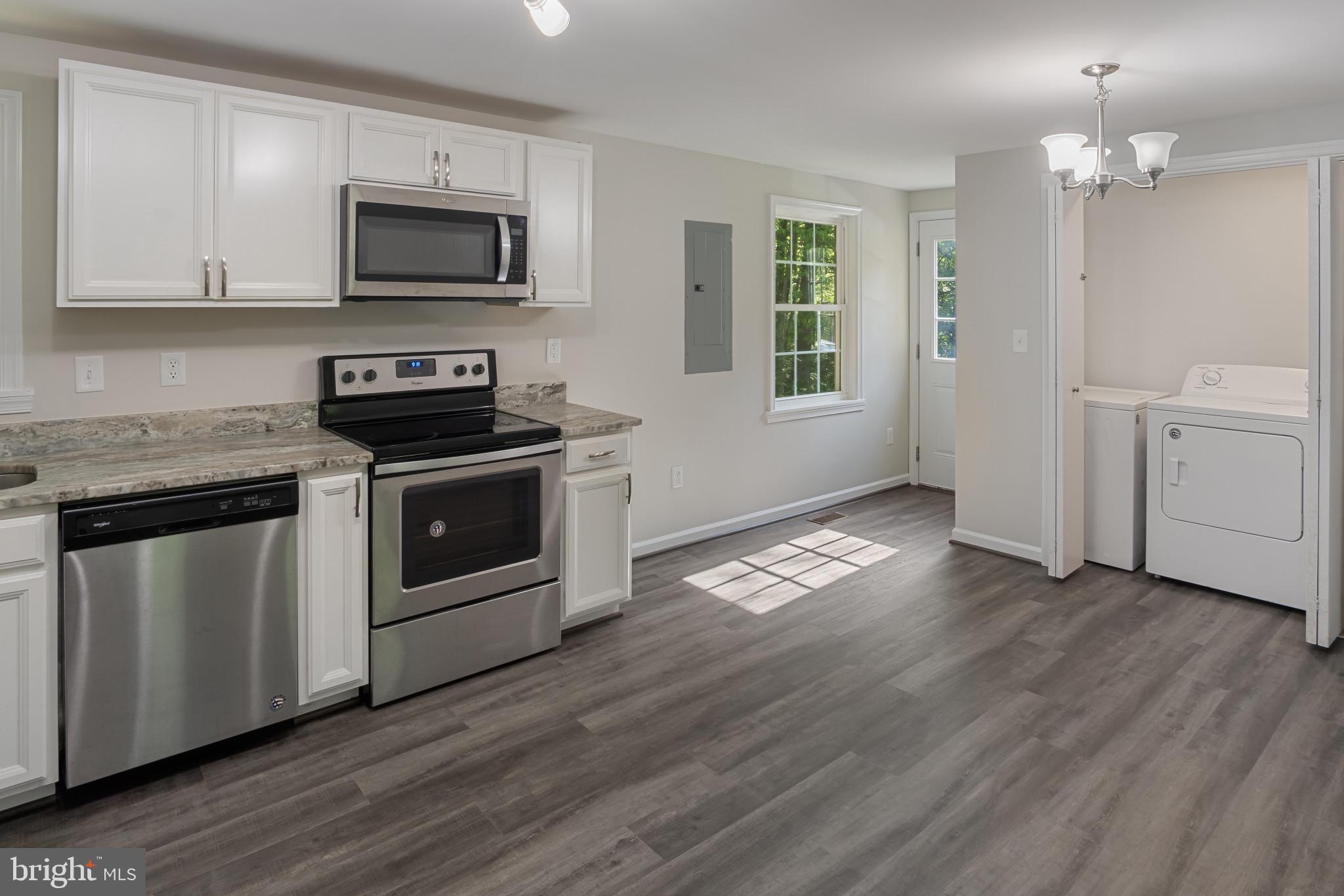 14408 Old Ridge Road Beaverdam, VA 23015 - Photo 11 of 26 a kitchen with a stove a sink and a microwave