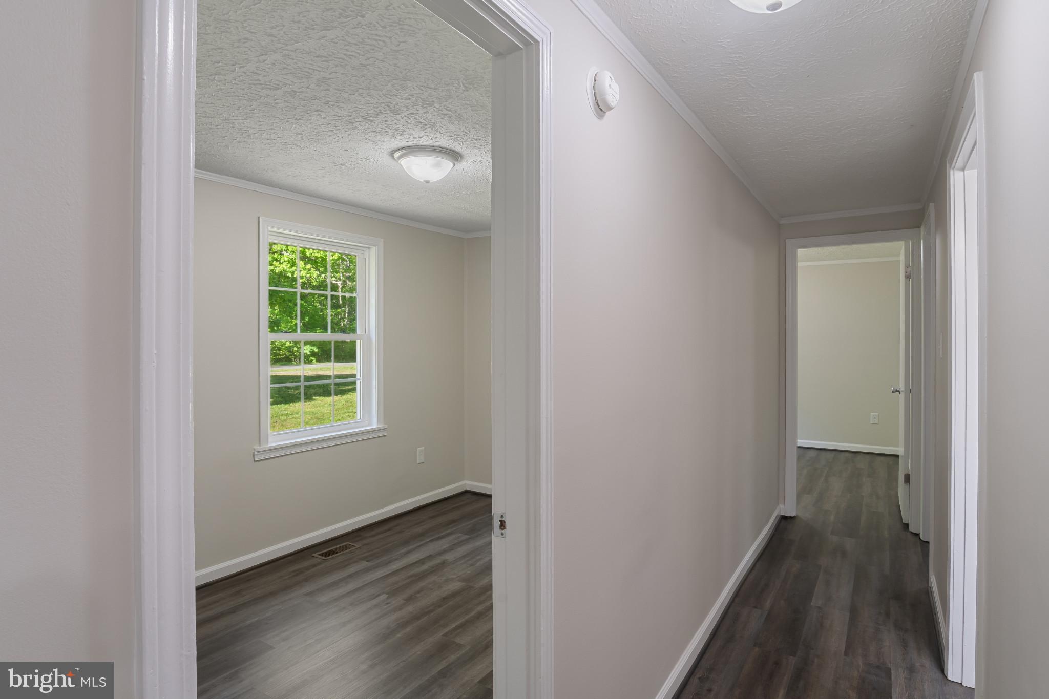 14408 Old Ridge Road Beaverdam, VA 23015 - Photo 13 of 26 an empty room with wooden floor and a window