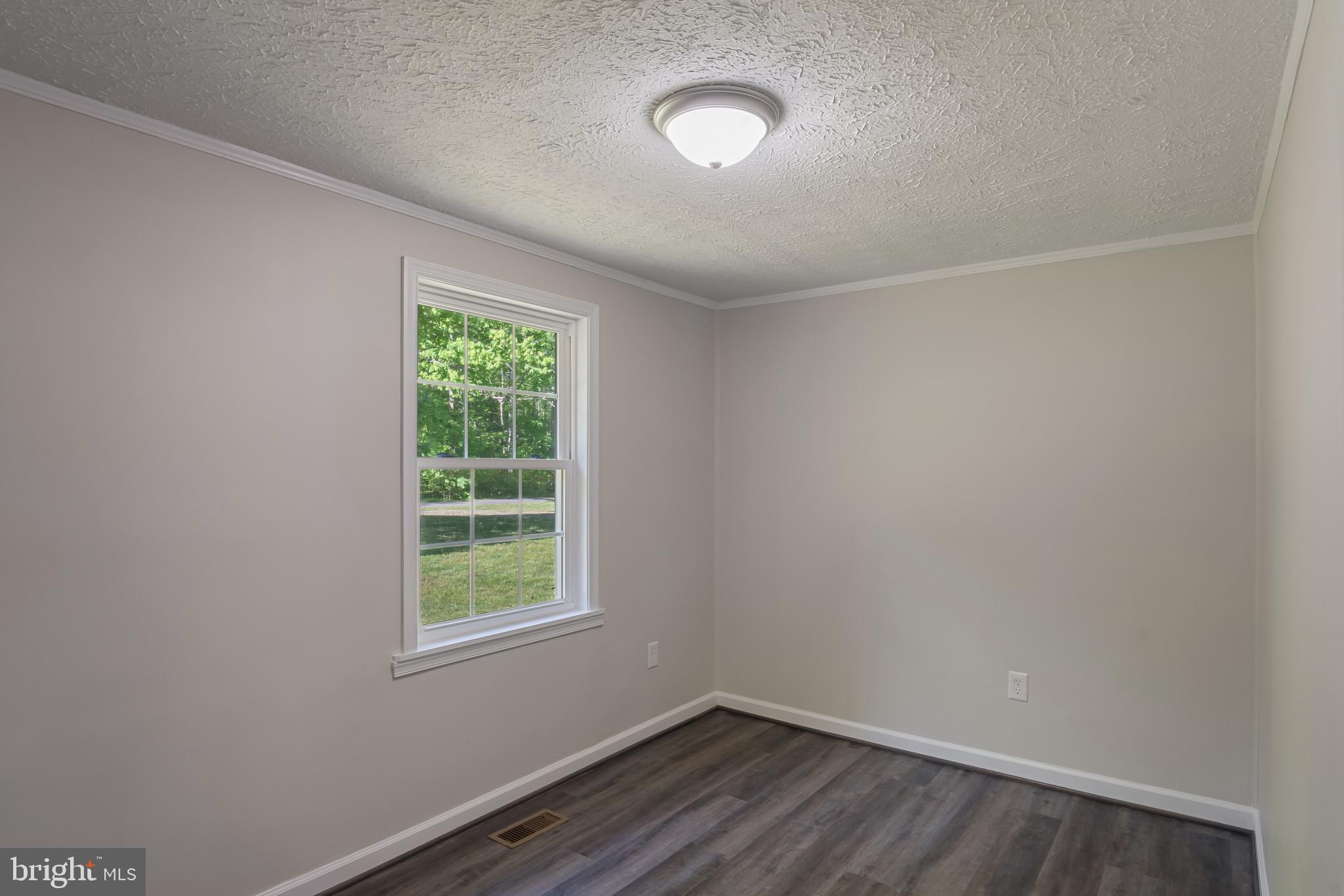14408 Old Ridge Road Beaverdam, VA 23015 - Photo 14 of 26 wooden floor in an empty room with a window