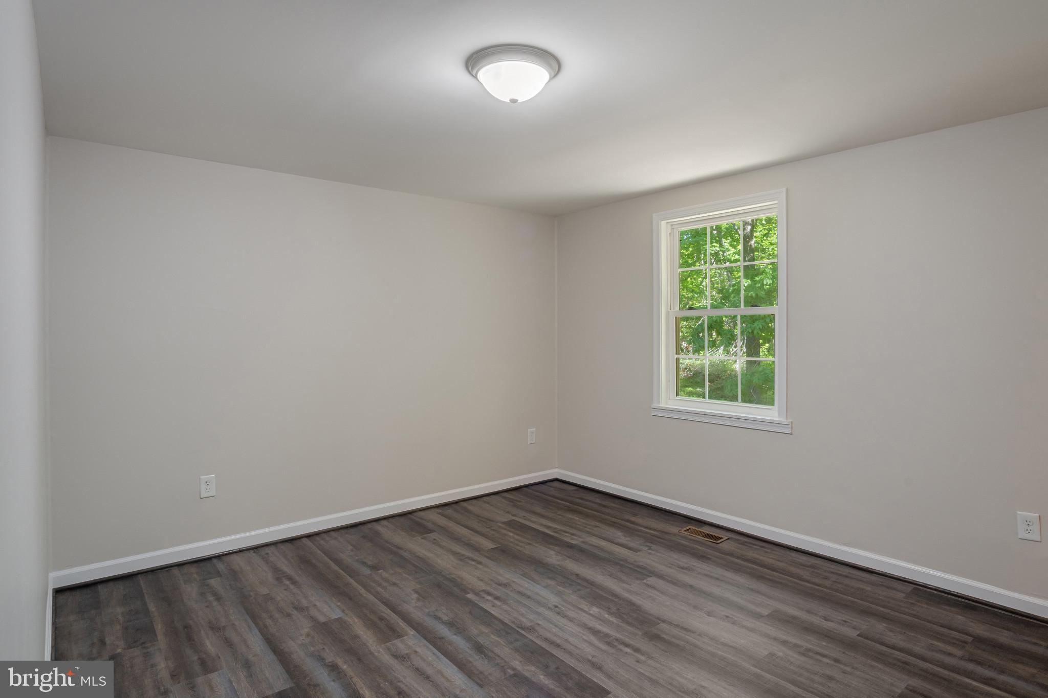 14408 Old Ridge Road Beaverdam, VA 23015 - Photo 16 of 26 an empty room with wooden floor and windows