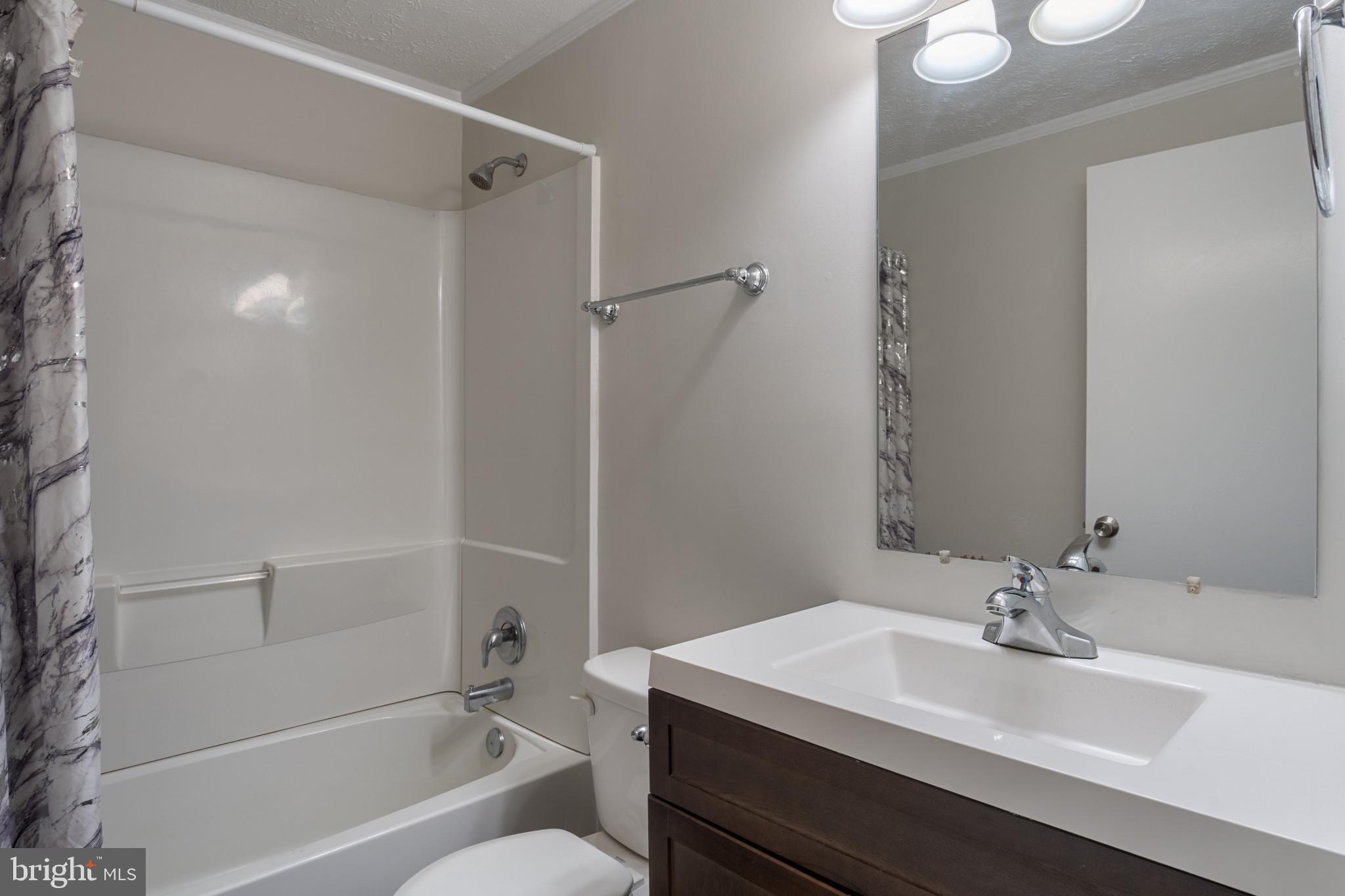 14408 Old Ridge Road Beaverdam, VA 23015 - Photo 20 of 26 a bathroom with a sink a toilet and shower