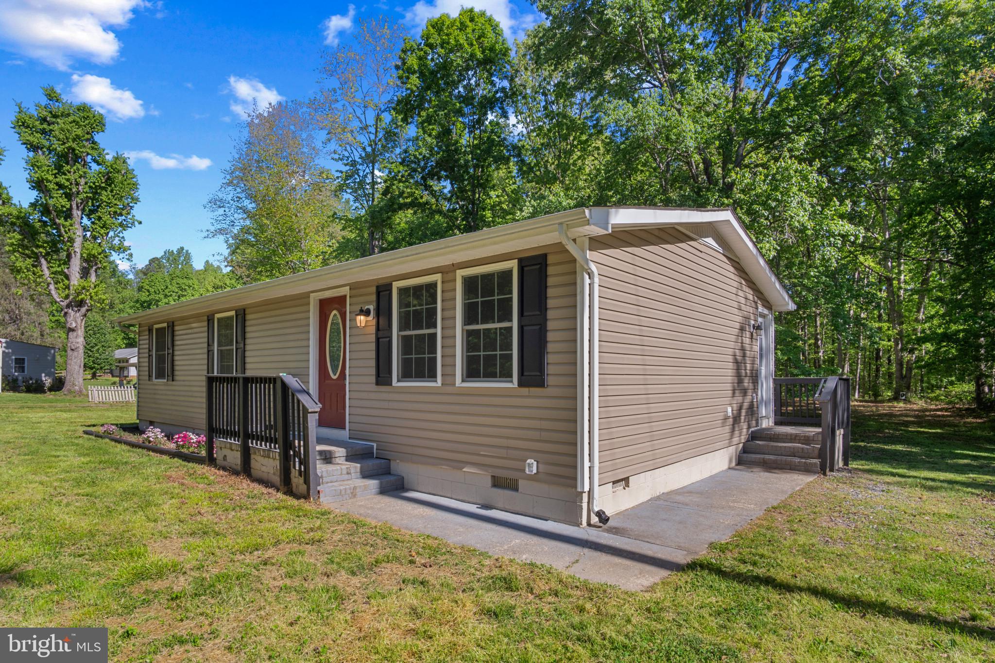 14408 Old Ridge Road Beaverdam, VA 23015 - Photo 3 of 26 a front view of house with yard and trees in the background