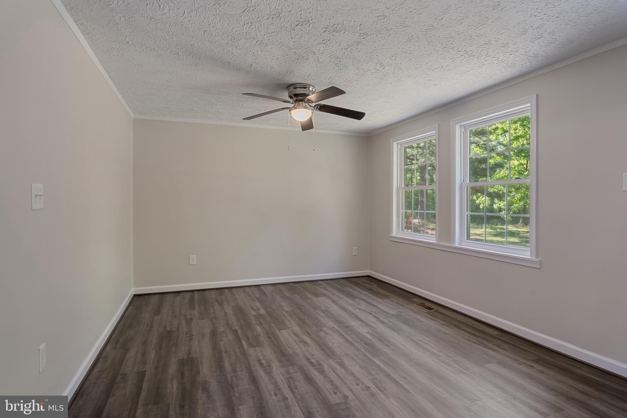 14408 Old Ridge Road Beaverdam, VA 23015 - Photo 5 of 26 an empty room with a window and a ceiling fan