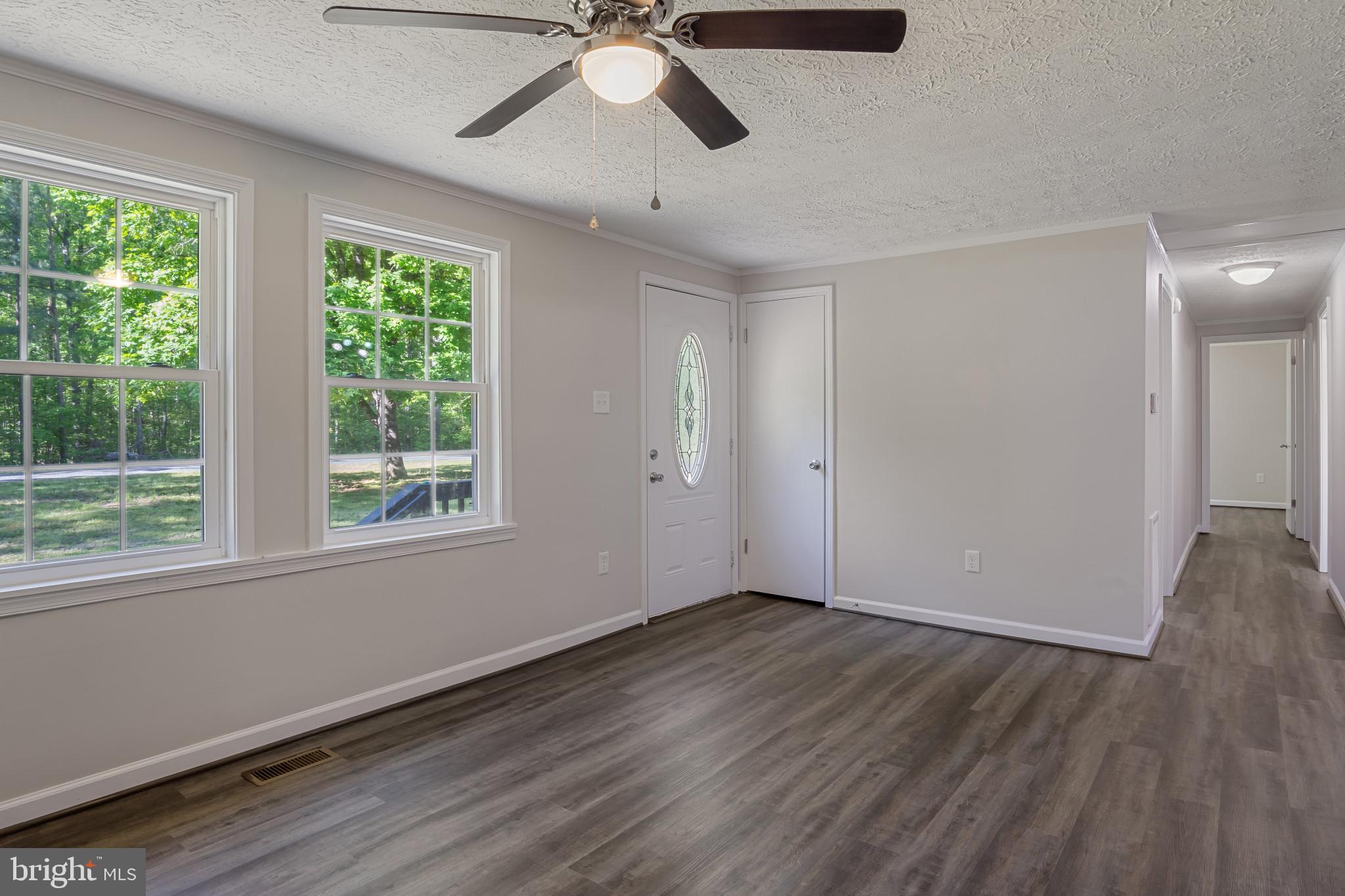 14408 Old Ridge Road Beaverdam, VA 23015 - Photo 6 of 26 a view of an empty room with wooden floor and a window