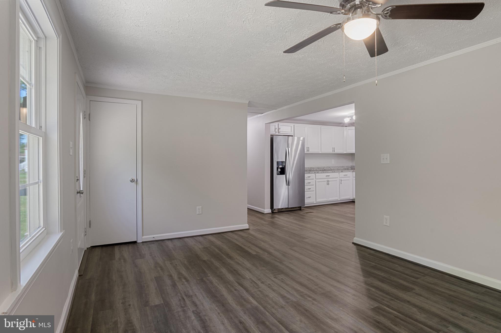 14408 Old Ridge Road Beaverdam, VA 23015 - Photo 7 of 26 a view of an empty room with wooden floor and a window
