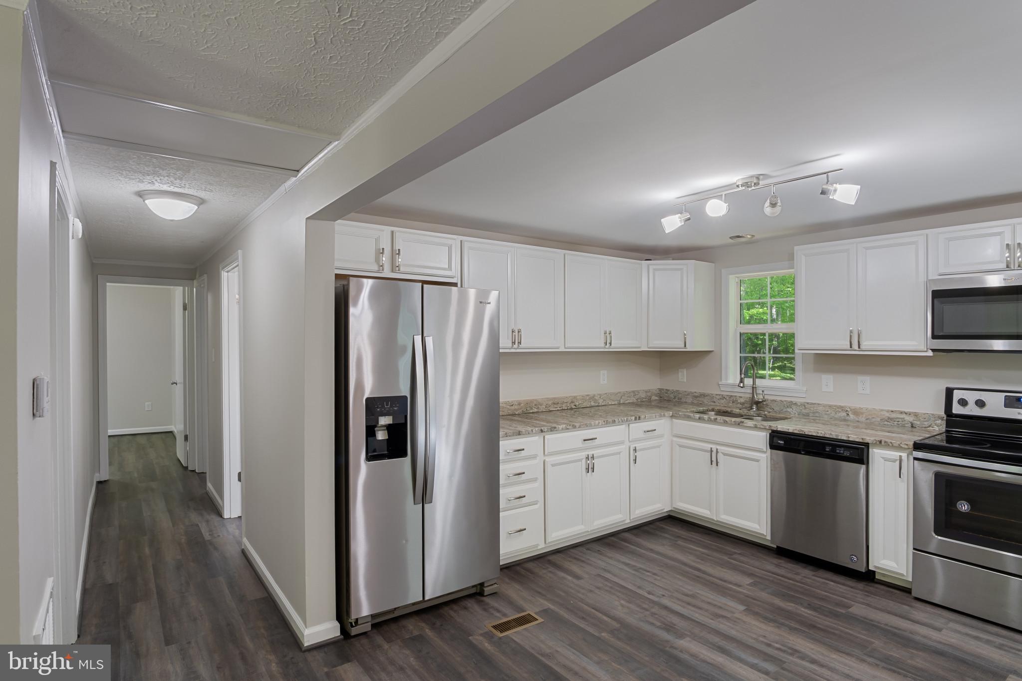 14408 Old Ridge Road Beaverdam, VA 23015 - Photo 8 of 26 a kitchen with stainless steel appliances granite countertop a refrigerator and a stove top oven