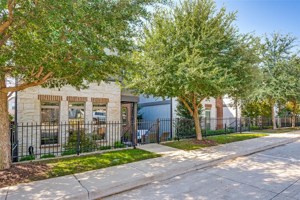 View of front facade featuring stone siding and a fenced front yard