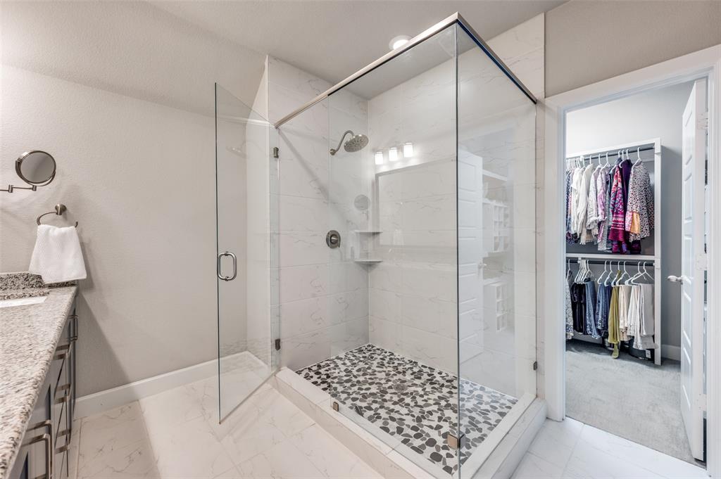 7153 Copperleaf Drive Dallas, TX 75231 - Photo 14 of 26 Full bathroom featuring a stall shower, vanity, light marble finish flooring, and a spacious closet