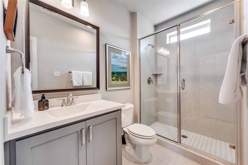 7153 Copperleaf Drive Dallas, TX 75231 - Photo 18 of 26 Full bathroom with vanity, a shower stall, and light tile patterned floors