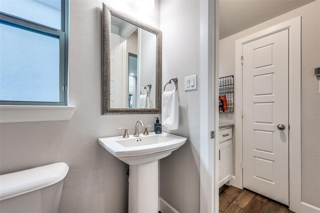 7153 Copperleaf Drive Dallas, TX 75231 - Photo 20 of 26 Bathroom with dark wood-style flooring, a textured wall, and a textured ceiling