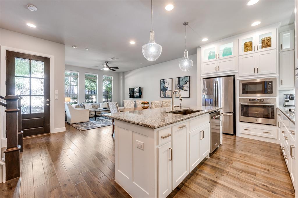 7153 Copperleaf Drive Dallas, TX 75231 - Photo 26 of 26 Kitchen with white cabinetry, stainless steel appliances, hanging light fixtures, open floor plan, and recessed lighting