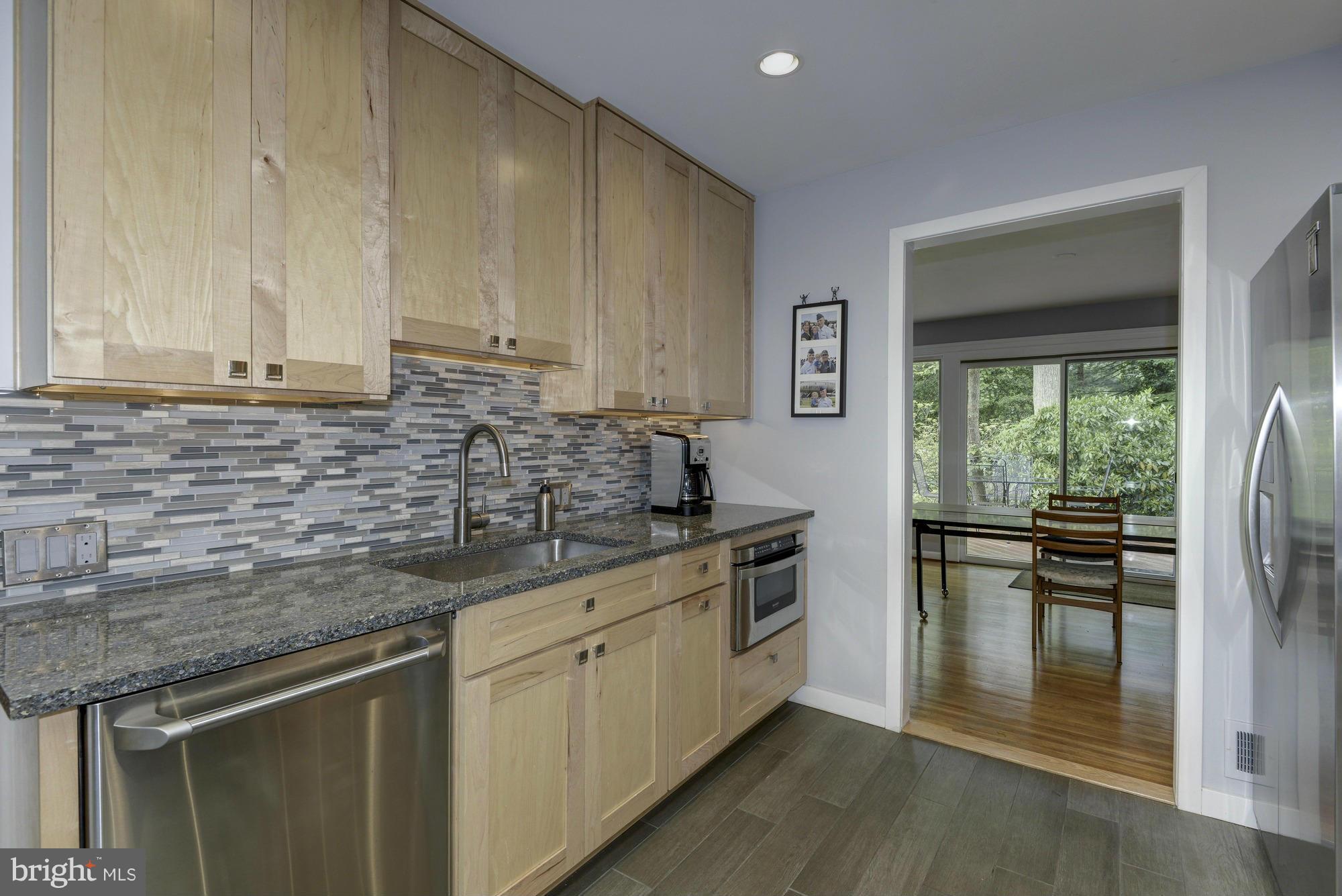 10823 Margate Road Silver Spring, MD 20901 - Photo 14 of 30 a kitchen with stainless steel appliances granite countertop a stove a sink and a microwave
