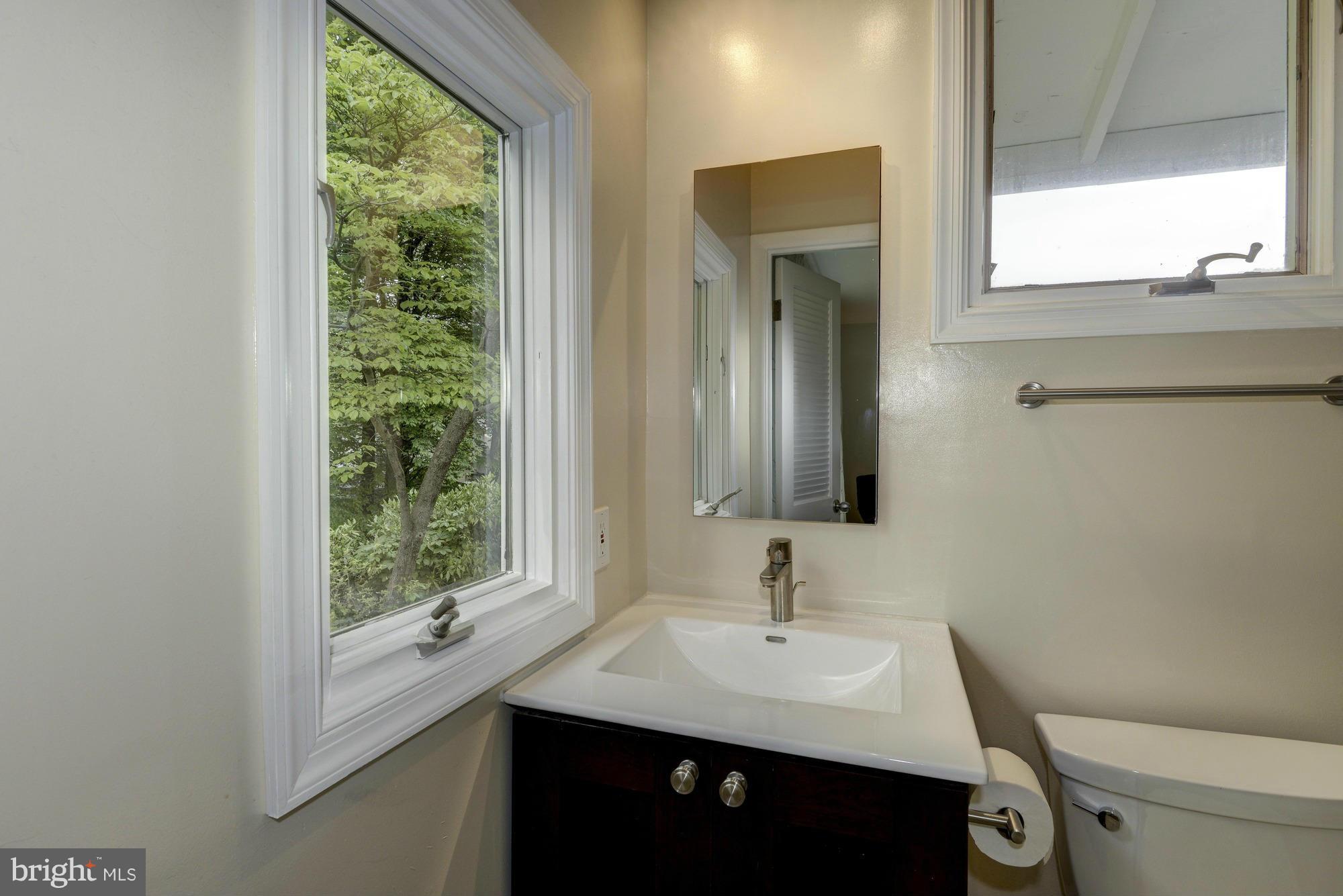 10823 Margate Road Silver Spring, MD 20901 - Photo 18 of 30 a bathroom with a sink a toilet and a window