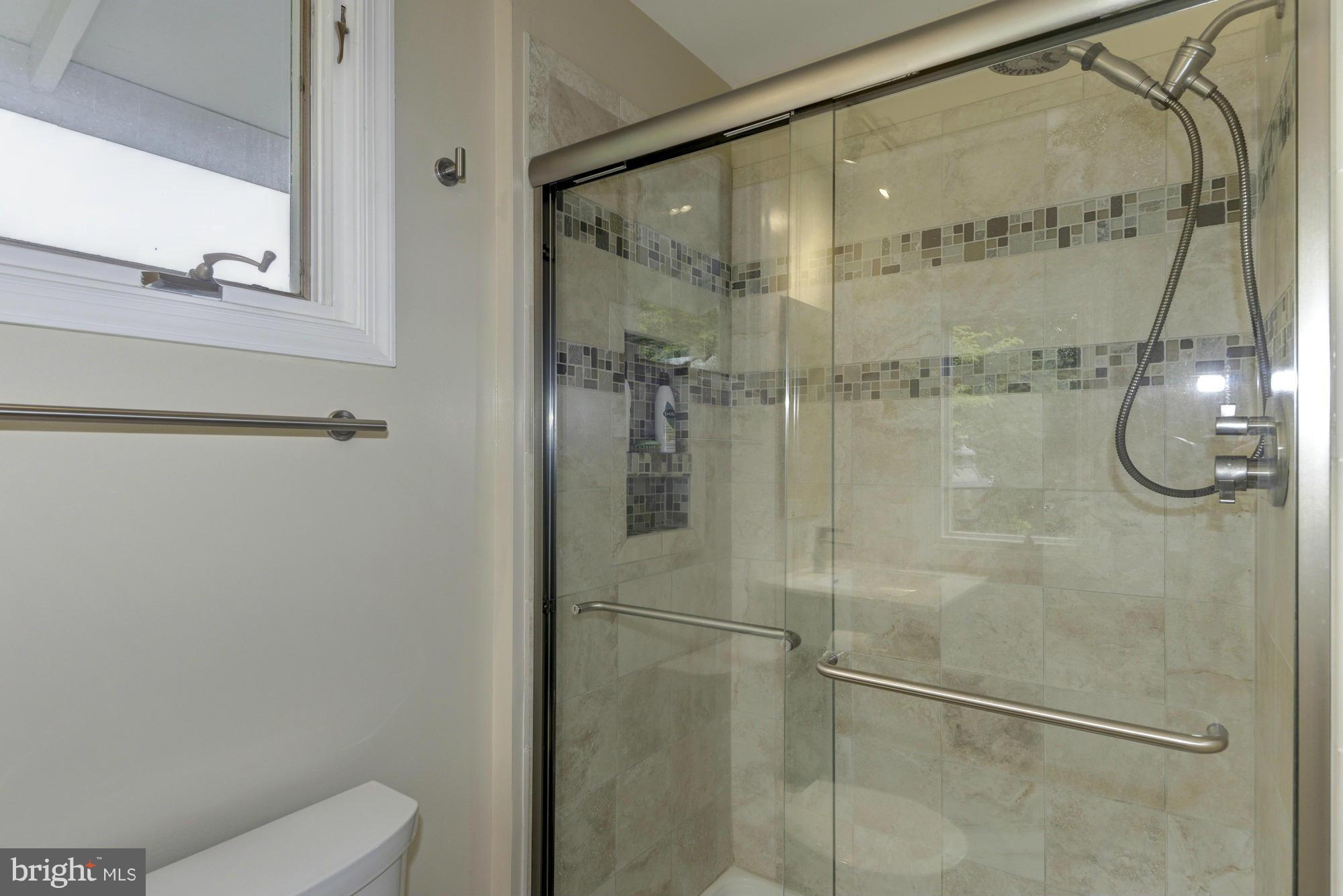 10823 Margate Road Silver Spring, MD 20901 - Photo 19 of 30 a bathroom with a glass shower door