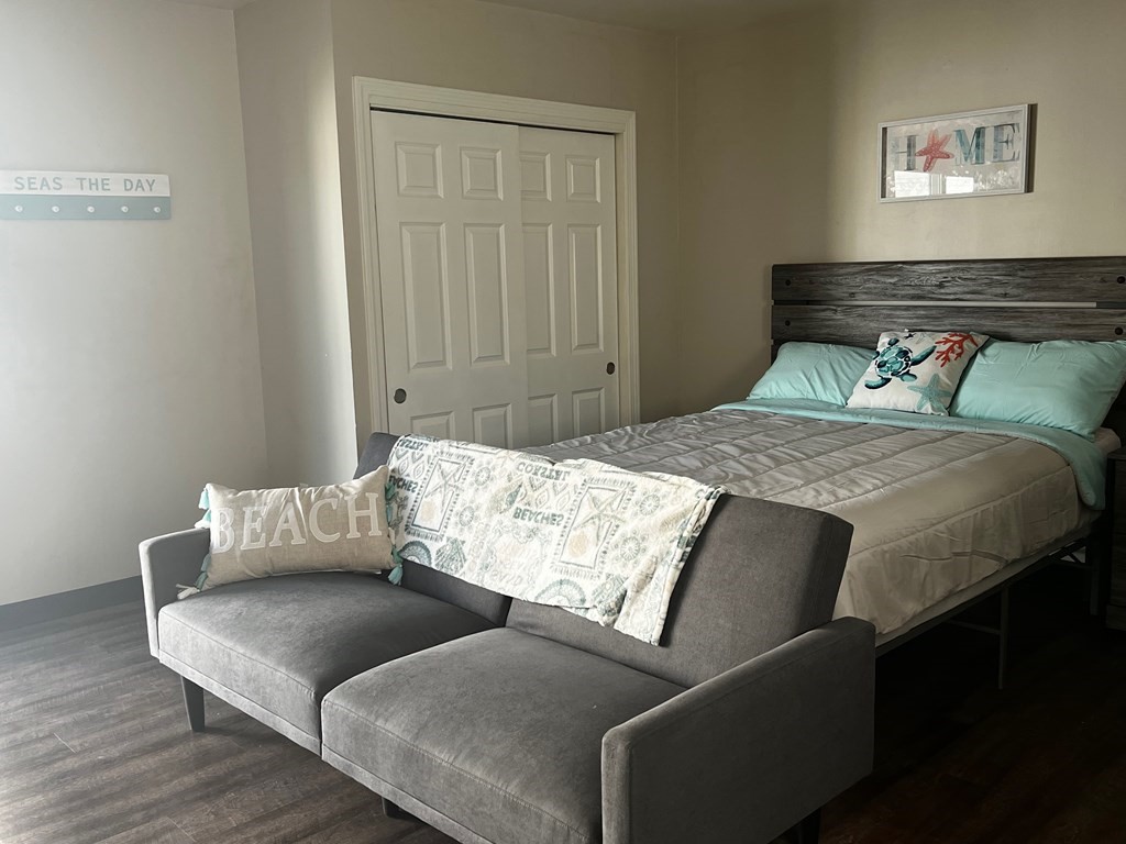 933 Ocean Boulevard, Unit 27 Hampton, NH 03842 - Photo 5 of 9 a bedroom with a bed and a couch