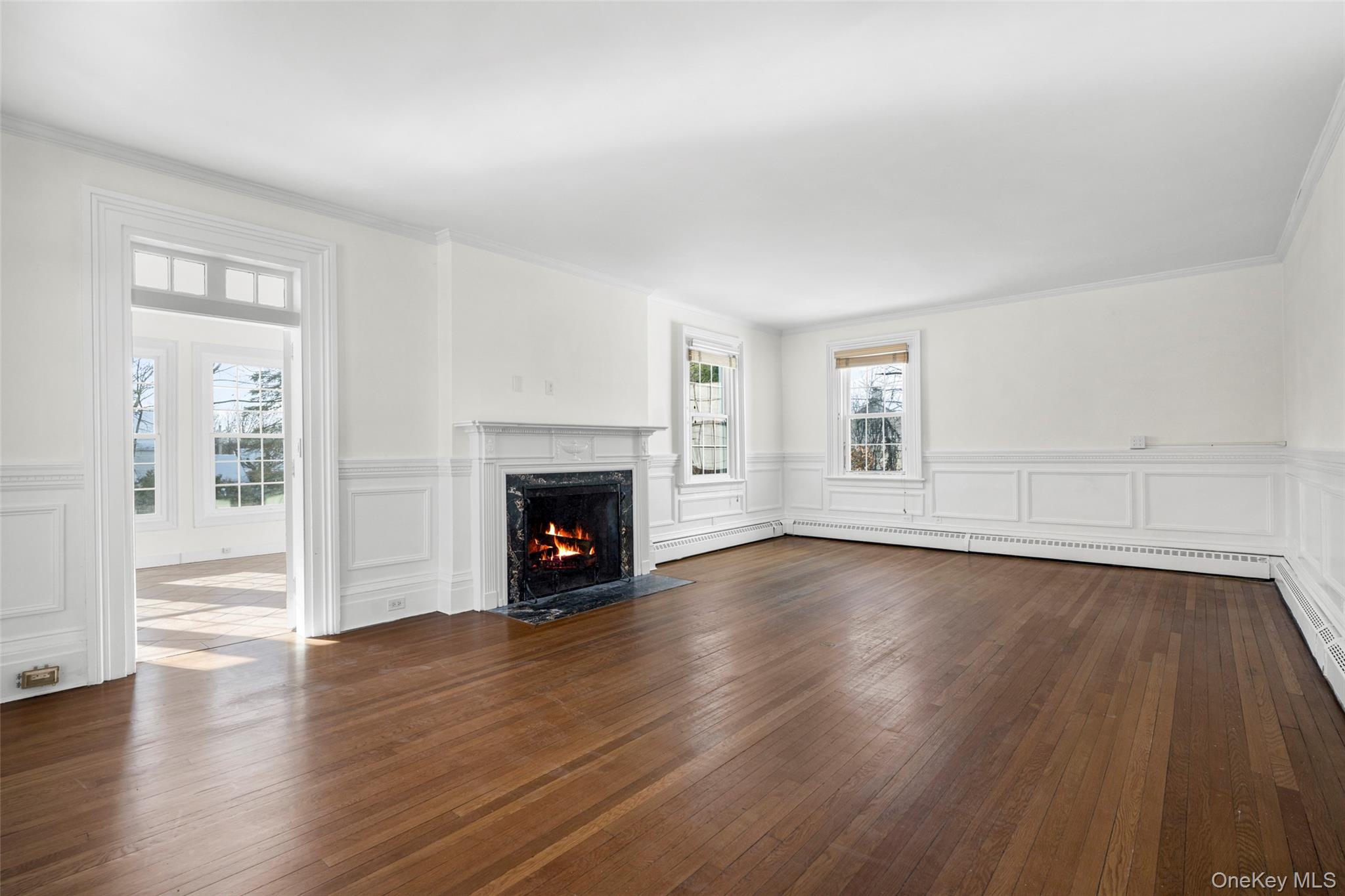 1146 North Avenue New Rochelle, NY 10804 - Photo 11 of 50 an empty room with wooden floor fireplace and windows