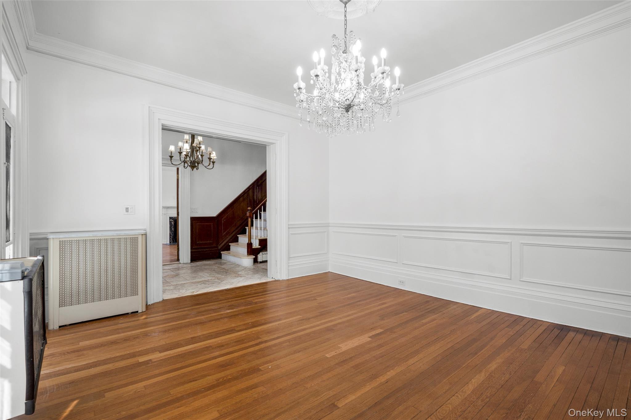 1146 North Avenue New Rochelle, NY 10804 - Photo 19 of 50 a view of a livingroom with wooden floor and staircase