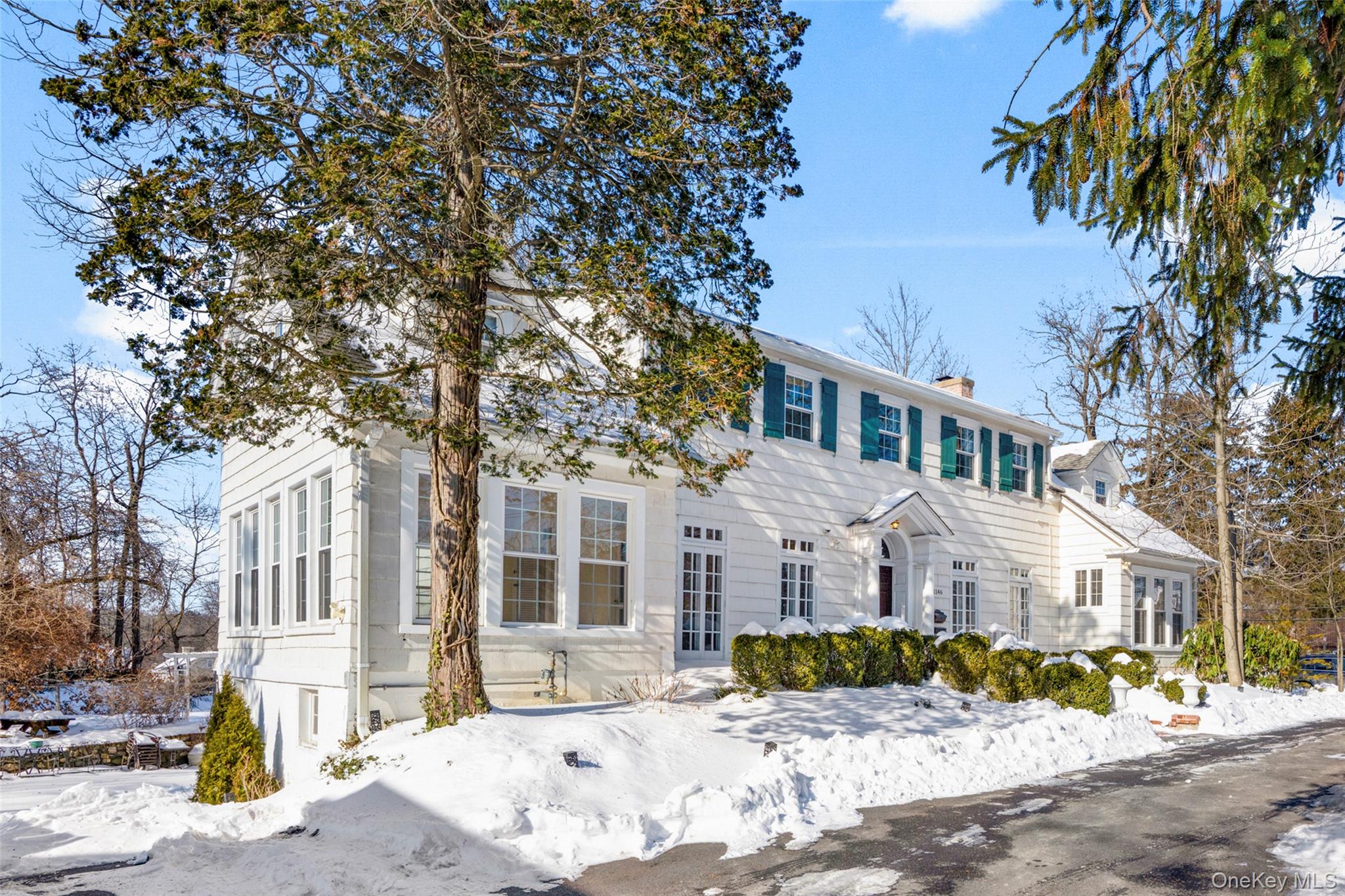 1146 North Avenue New Rochelle, NY 10804 - Photo 3 of 50 a view of a white house with a large tree