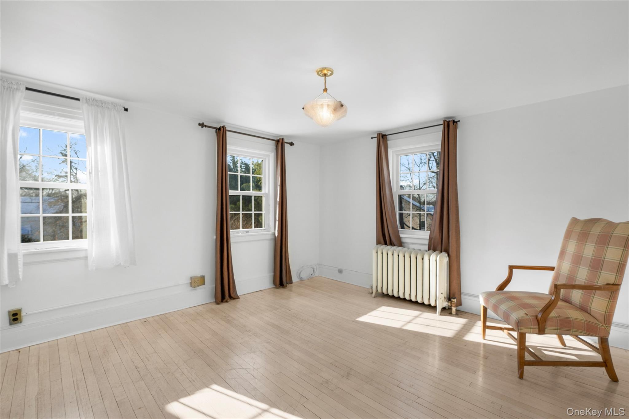 1146 North Avenue New Rochelle, NY 10804 - Photo 33 of 50 a view of an empty room with wooden floor and a window