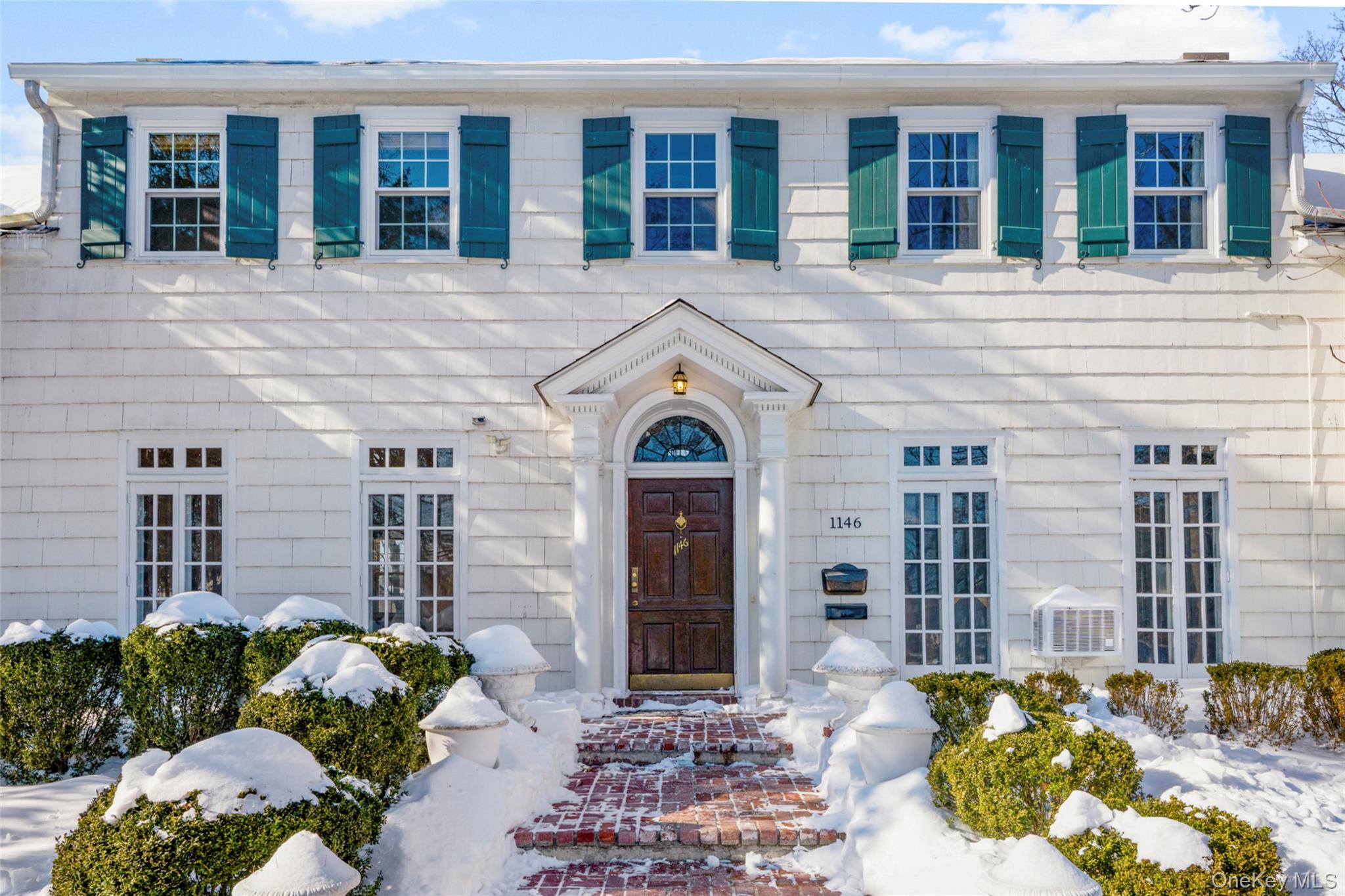 1146 North Avenue New Rochelle, NY 10804 - Photo 5 of 50 a front view of a house with a garden