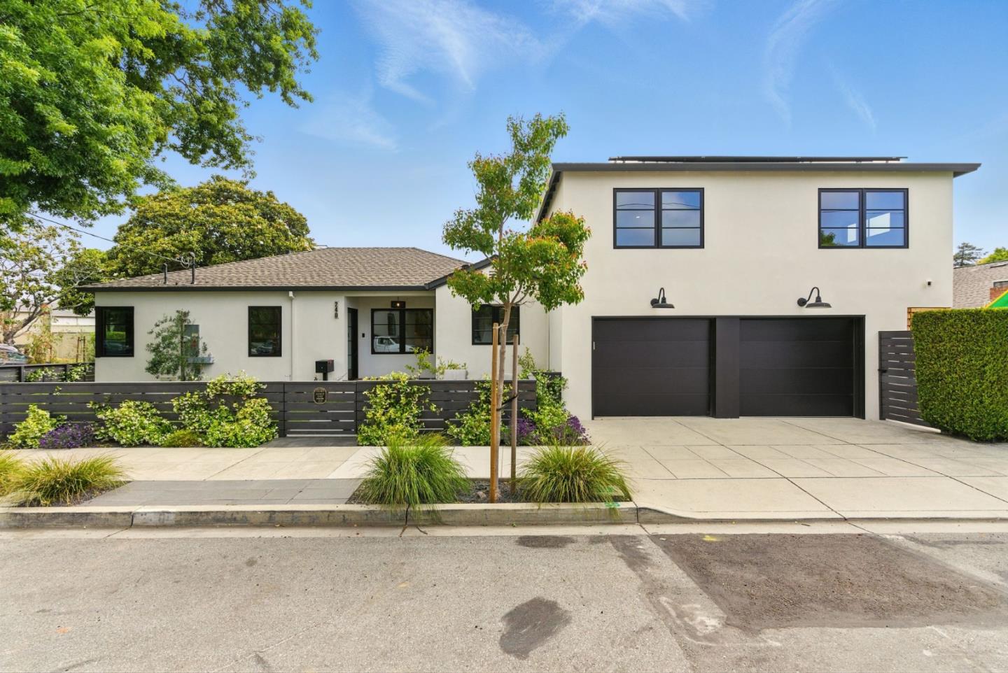 a front view of a house with a yard and a garage