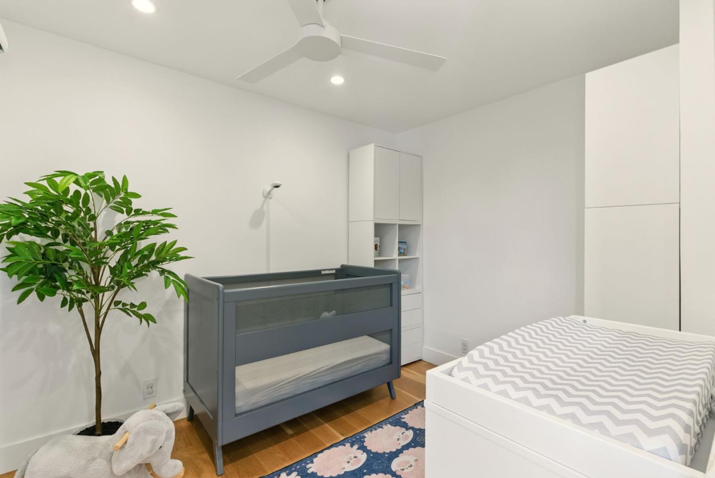 240 Bancroft Road Burlingame, CA 94010 - Photo 23 of 41 a bedroom with a bed and a potted plant