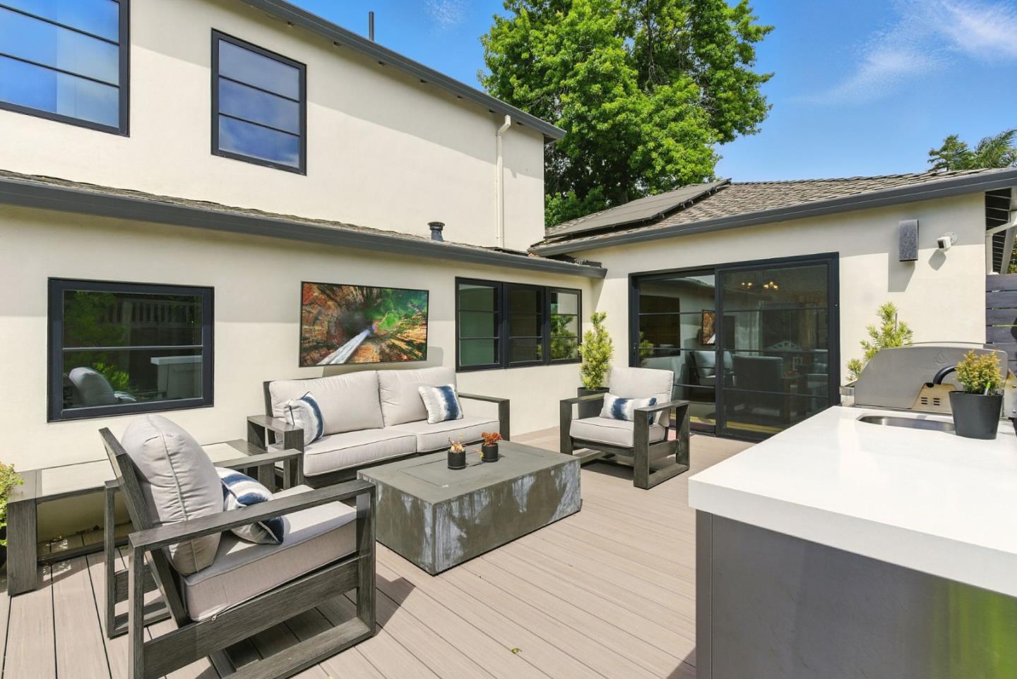 240 Bancroft Road Burlingame, CA 94010 - Photo 27 of 41 a view of a patio with couches table and chairs with wooden floor