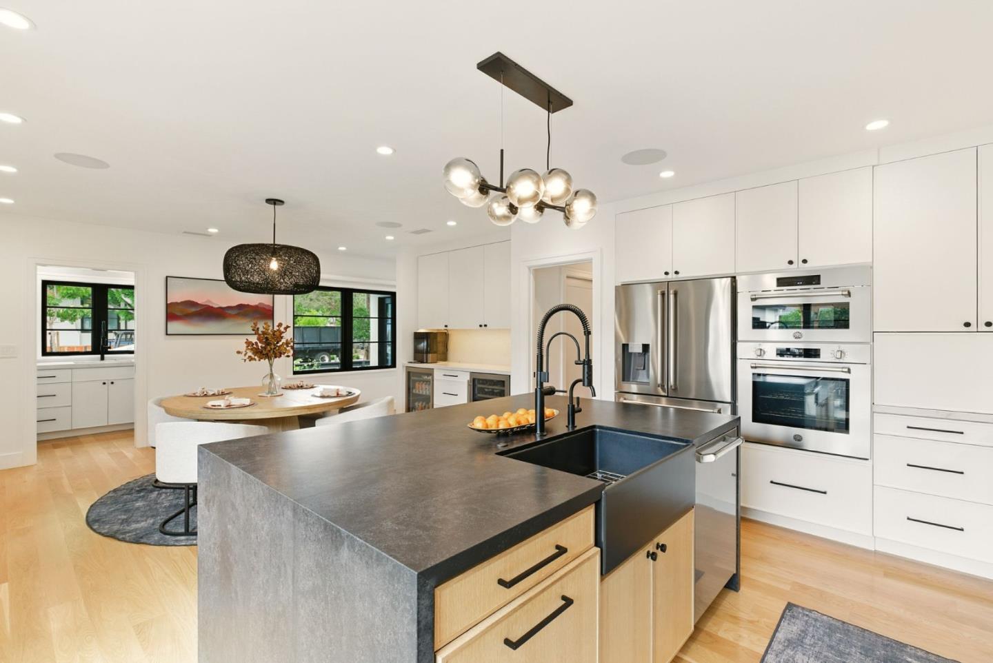 240 Bancroft Road Burlingame, CA 94010 - Photo 8 of 41 a kitchen with stainless steel appliances granite countertop a sink a stove and chairs