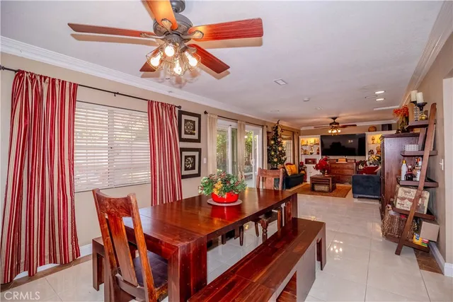 a living room with furniture a flat screen tv and a chandelier