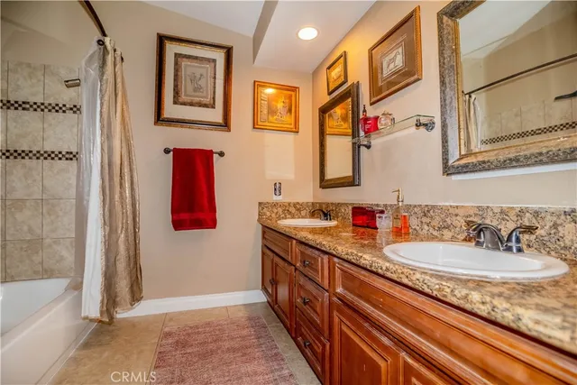 a bathroom with double vanity sink and a mirror
