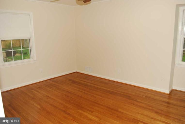 1904 Old Stage Road Alexandria, VA 22308 - Photo 16 of 21 an empty room with wooden floor and windows