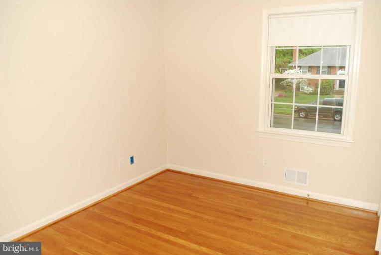 1904 Old Stage Road Alexandria, VA 22308 - Photo 17 of 21 an empty room with wooden floor and windows